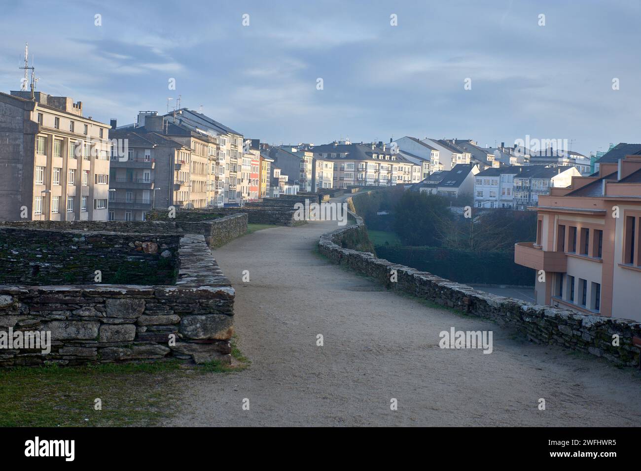 LUGO,SPAIN; January,27,2024:Roman wall of Lugo next to the houses of the city. Galicia. Stock Photo