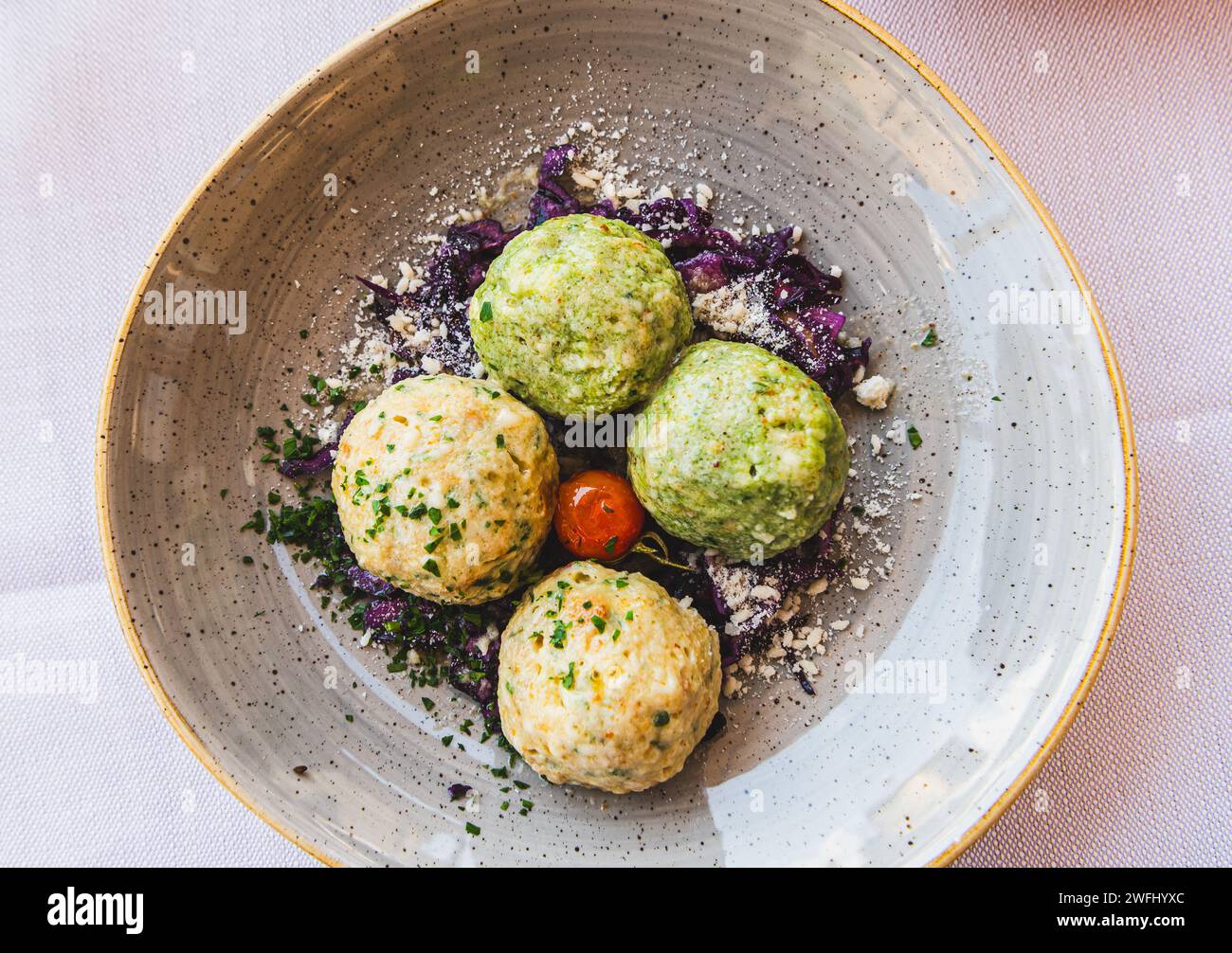 Knödel or Canederli bread dumplings, a typical speciality of Alto Adige or South Tyrol, Trentino Alto Adige, northern Italy Stock Photo