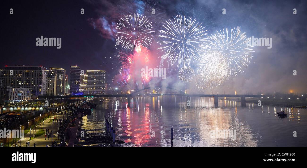 New Years Eve with colorful Fireworks over Belgrade City skyline with long exposure with dark blue sky and beautiful reflection on river Stock Photo