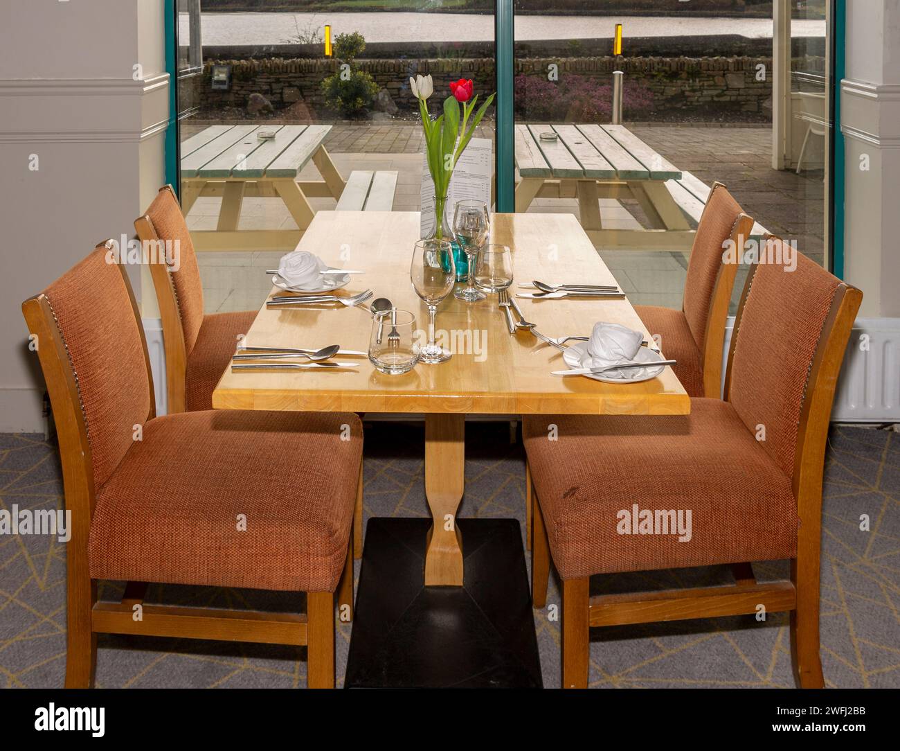 Restaurant table with empty seats. Stock Photo