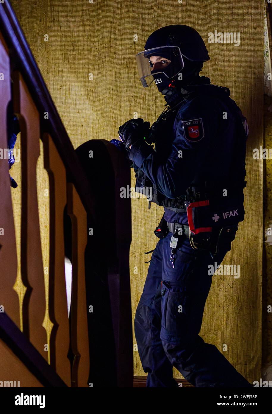 Hohenbostel, Germany. 03rd Jan, 2024. Police officers from the Lüneburg disposition unit practise entering a building. Credit: Philipp Schulze/dpa/Alamy Live News Stock Photo