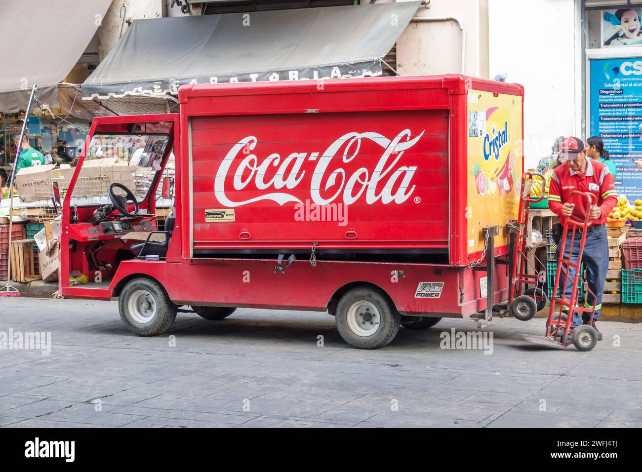Merida Mexico,centro historico central historic district,Calle 56,Coca-Cola delivery van truck,worker driver using dolly,man men male,adult adults,res Stock Photo