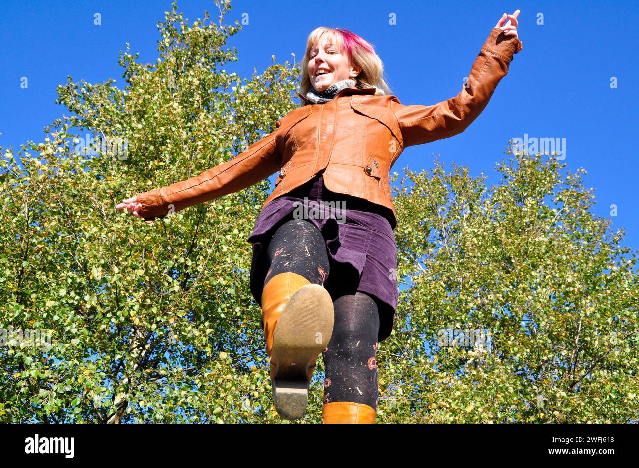A blonde woman in an unusual perspective. Fall outfit. Brilon, Germany Stock Photo