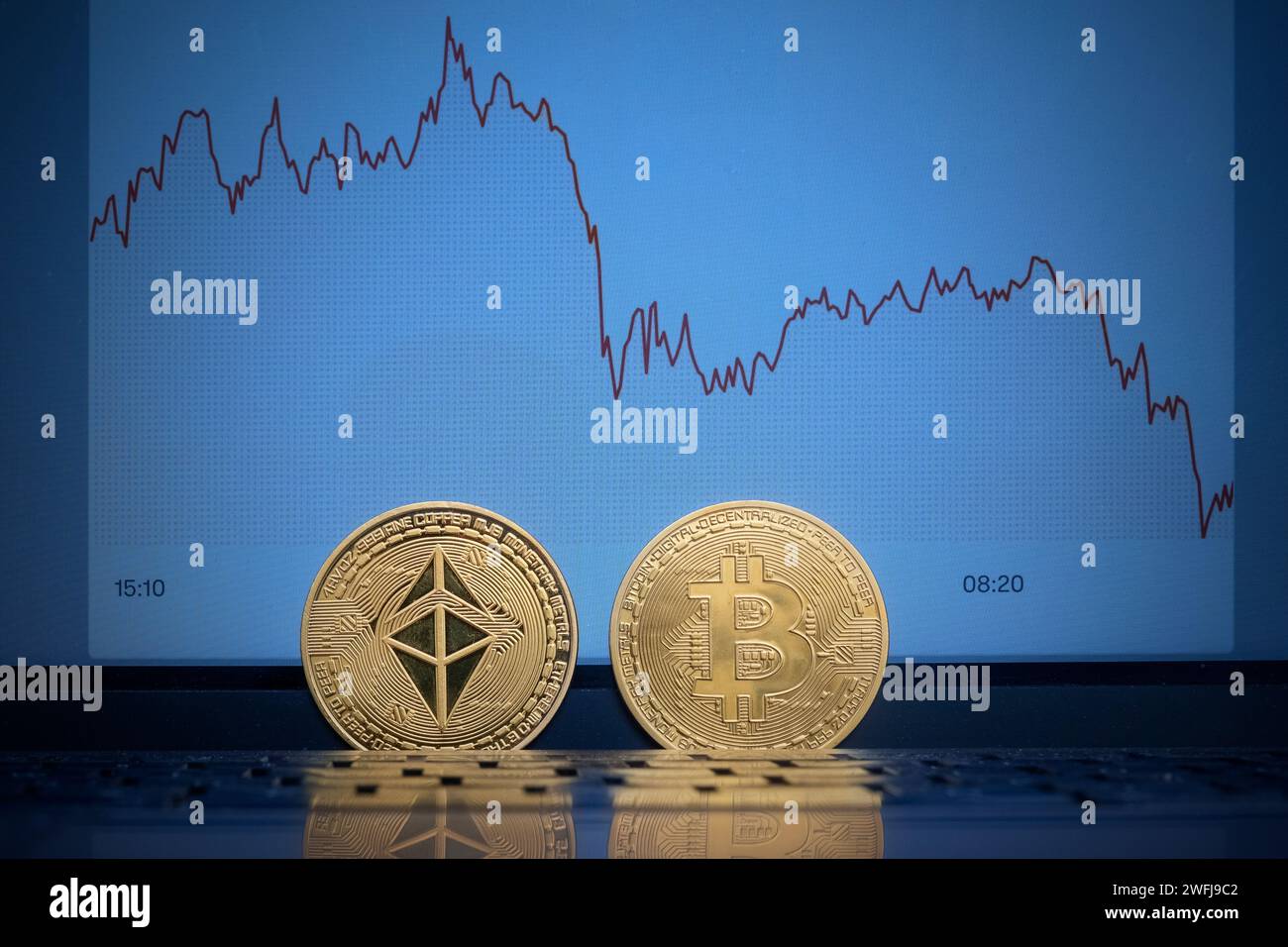 Ethereum and Bitcoin coin in front of a Bitcoin chart Stock Photo