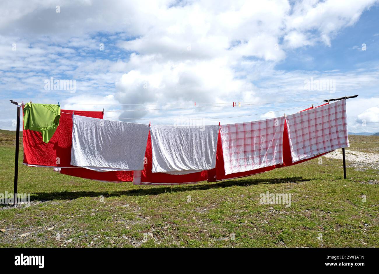 Sheets hang out to dry outside a mountain retreat of the Dolomites mountains Stock Photo