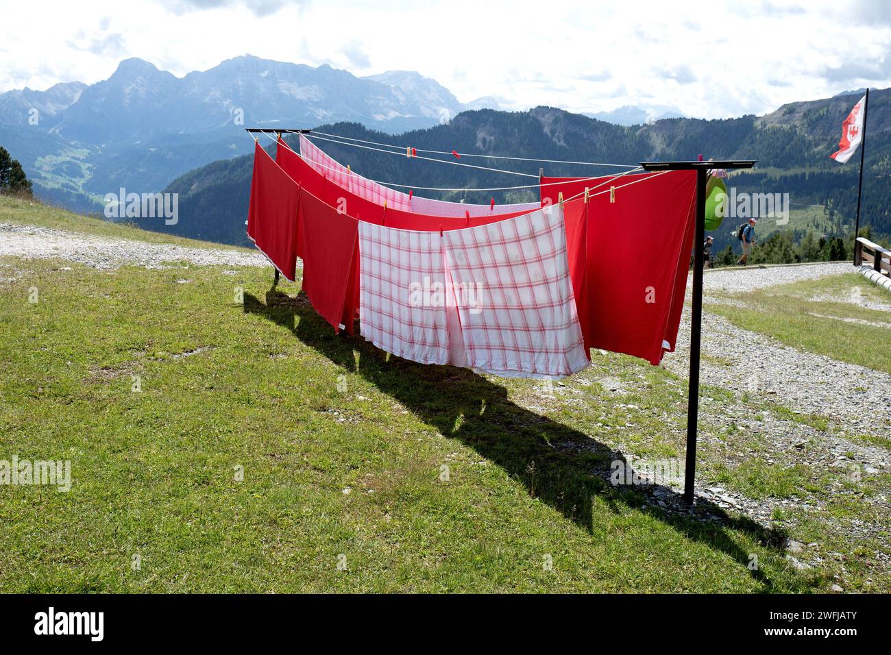 Sheets hang out to dry outside a mountain retreat of the Dolomites mountains Stock Photo