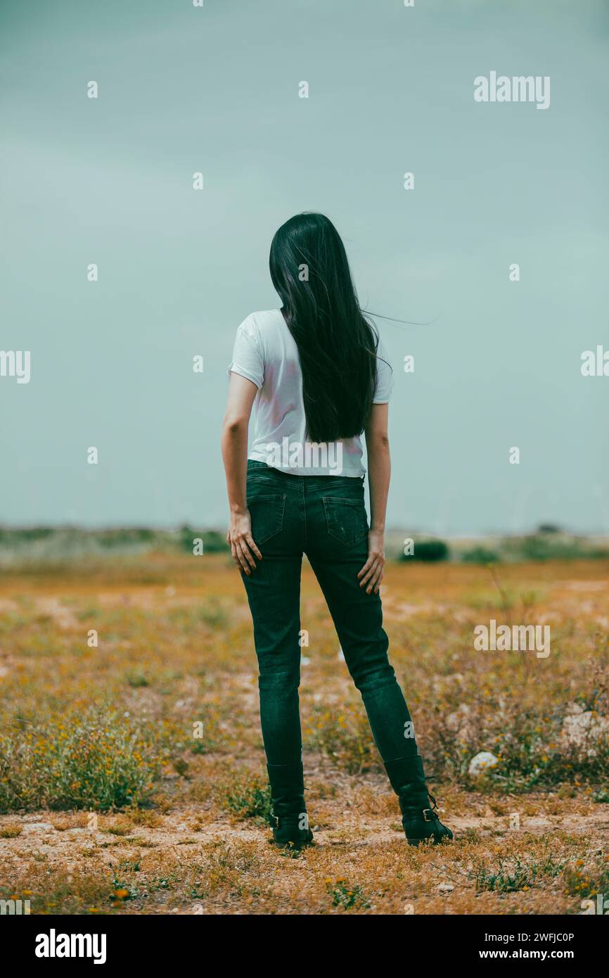 Woman standing in field rear view hi-res stock photography and images ...