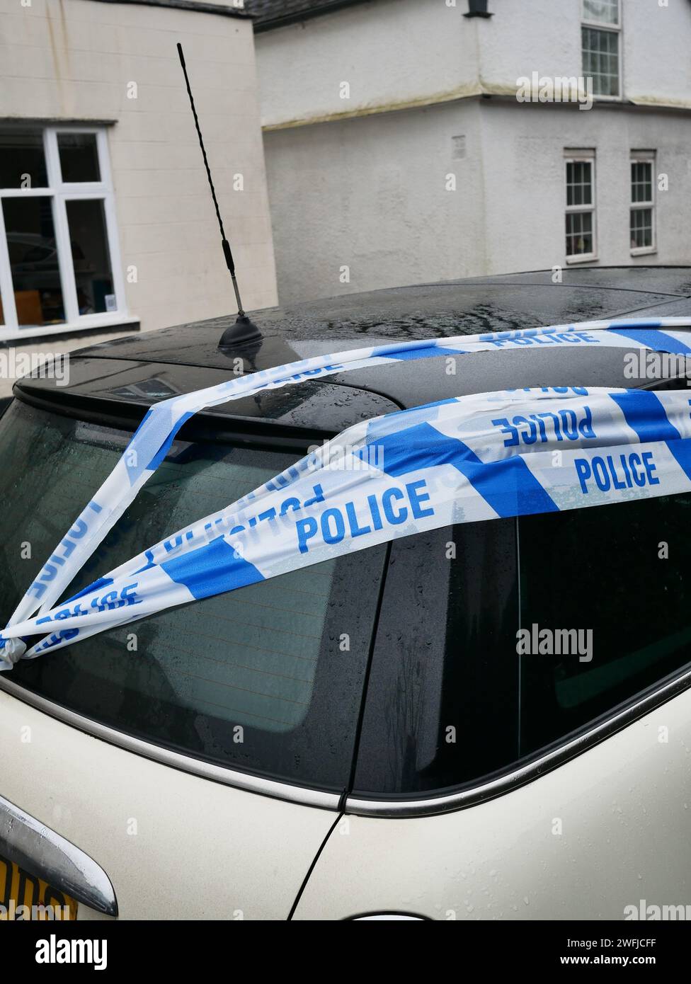 Police crime scene tape over a car Stock Photo