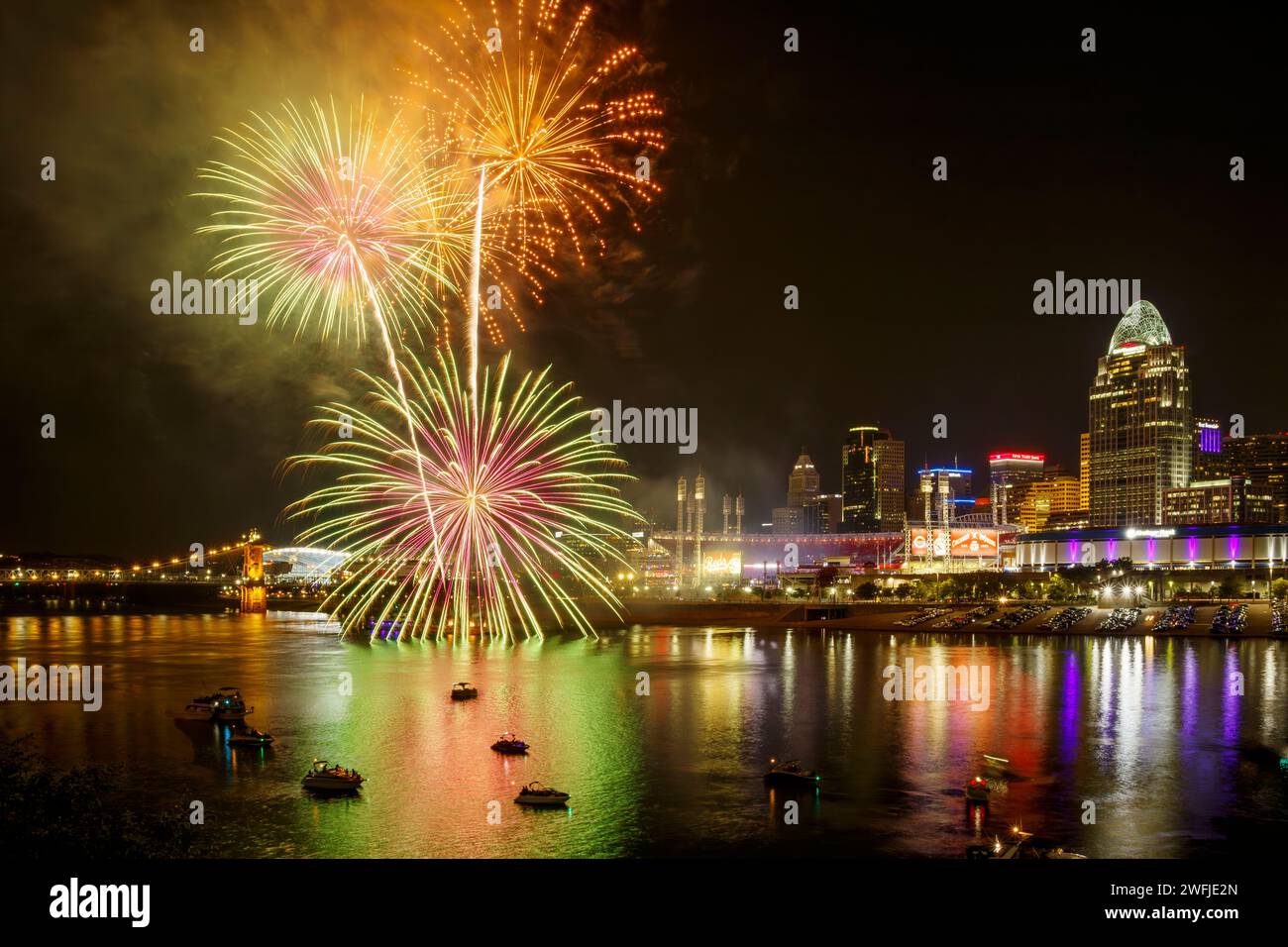 Cincinnati Reds Friday night fireworks. Cincinnati, Ohio, skyline. Cincinnati Reds baseball sign and stadium near center. Viewed across the Ohio River Stock Photo