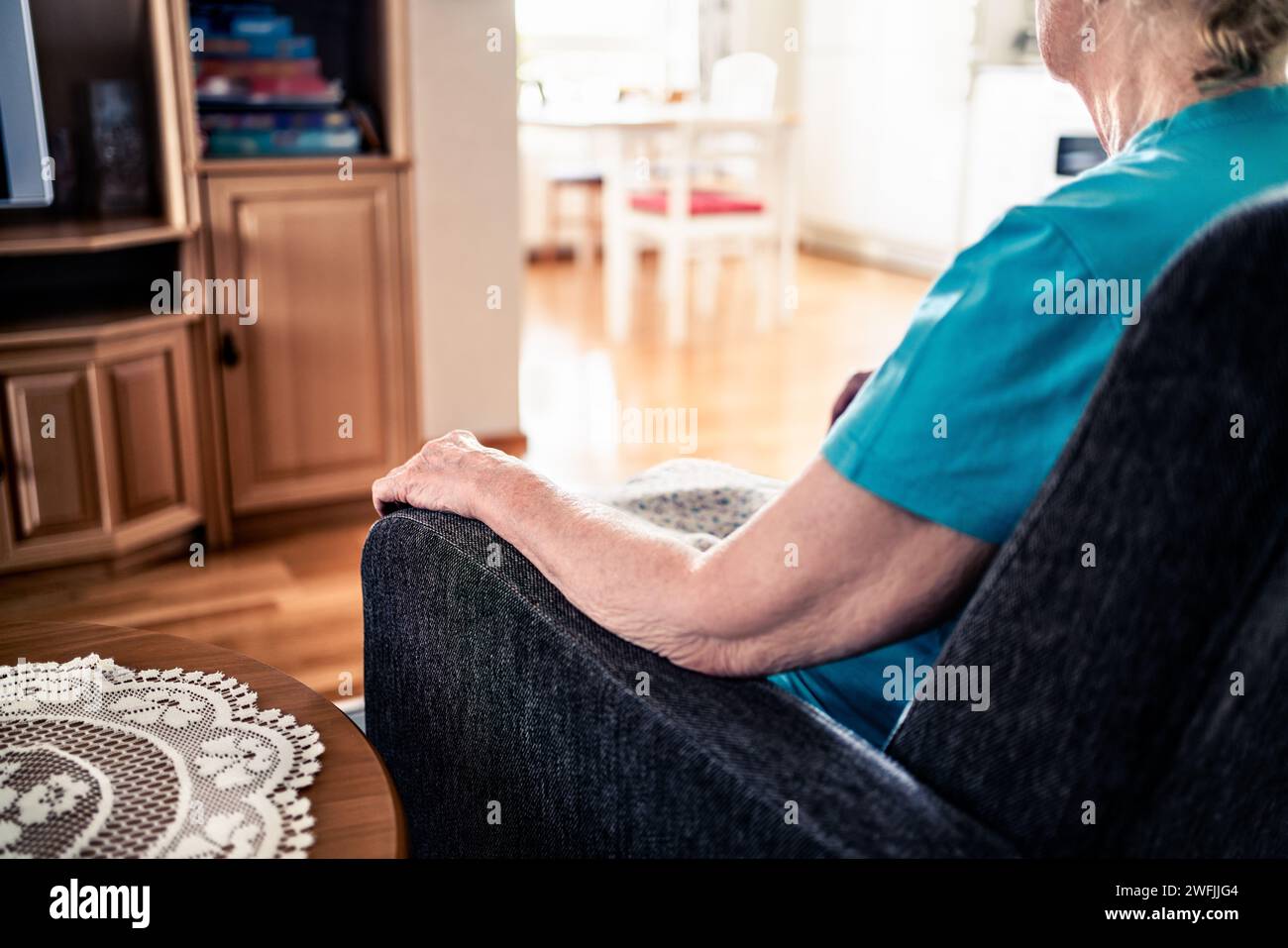 Lonely old senior woman with dementia, alzheimer or anxiety. Loneliness, grief or memory loss of a sad grandma. Home sofa couch. Family stress or sick. Stock Photo