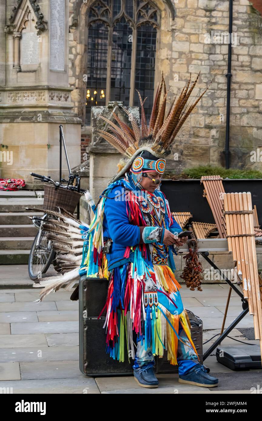 Inca tribal entertainer taking a rest, High Street, Lincoln City, Lincolnshire, England, UK Stock Photo