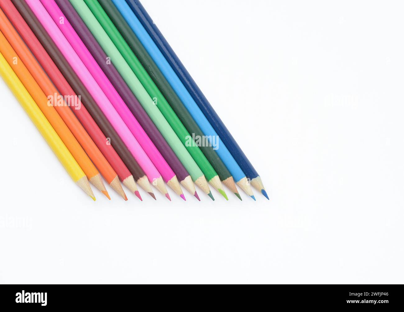 Set of seamless wooden coloured pencils placed in a row isolated on light background Stock Photo