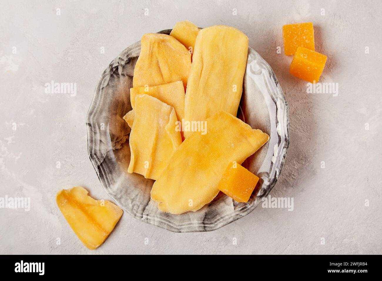 Tropical delight snack - captivating imagery of healthy dried mango treats. Stock Photo