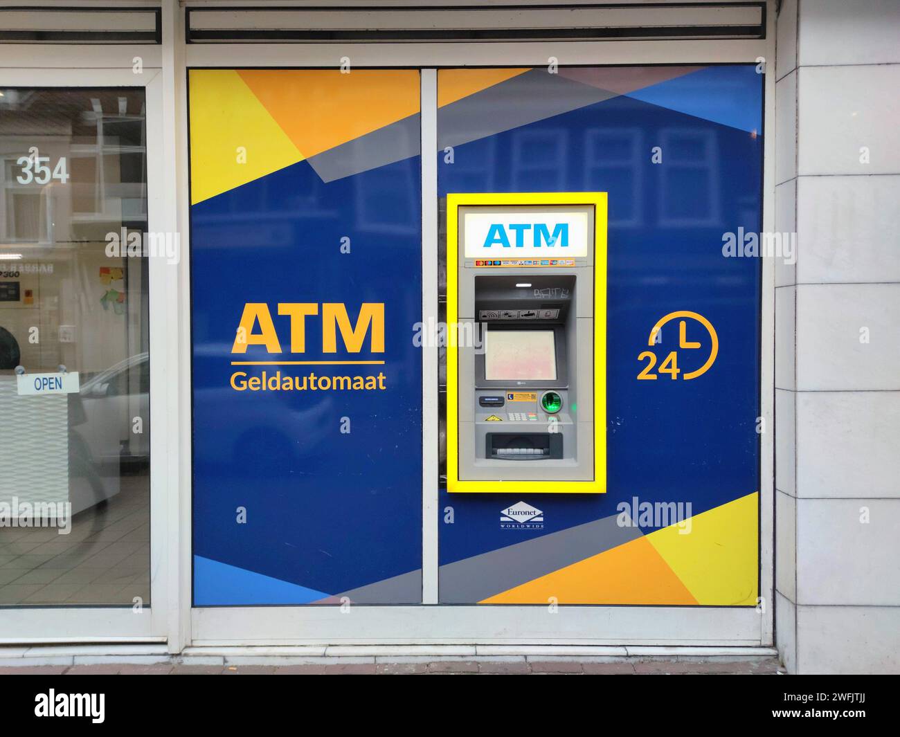 ATM machine in a Dutch shopping street in the city of The Hague, Netherlands. Stock Photo