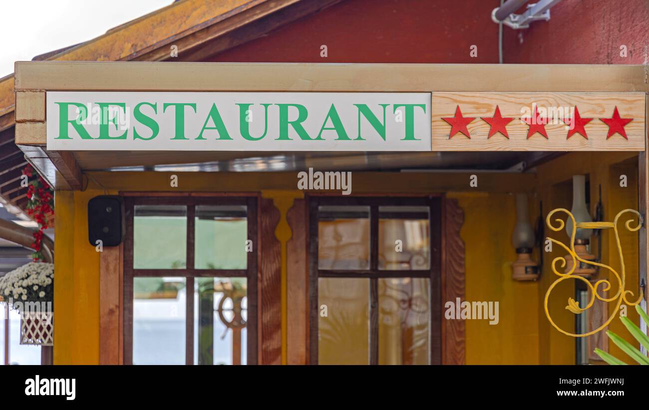Five Red Stars at Wood Plank and Restaurant Sign Stock Photo