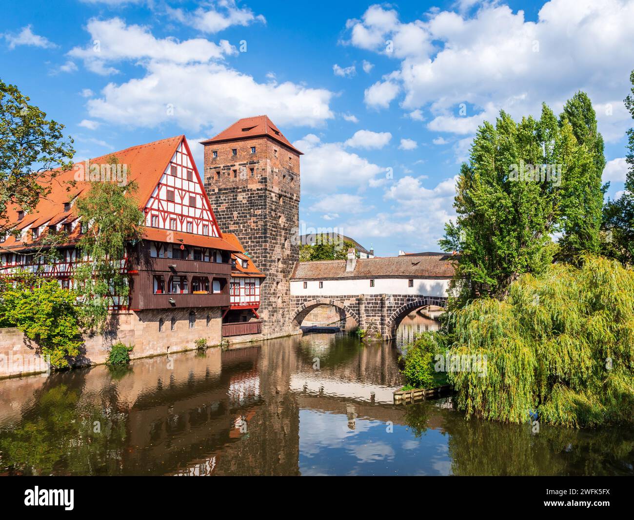The Weinstadel half-timbered building and the Wasserturm stone tower in Nuremberg, Germany, overlooking the Pegnitz river and the Henkerbrücke. Stock Photo