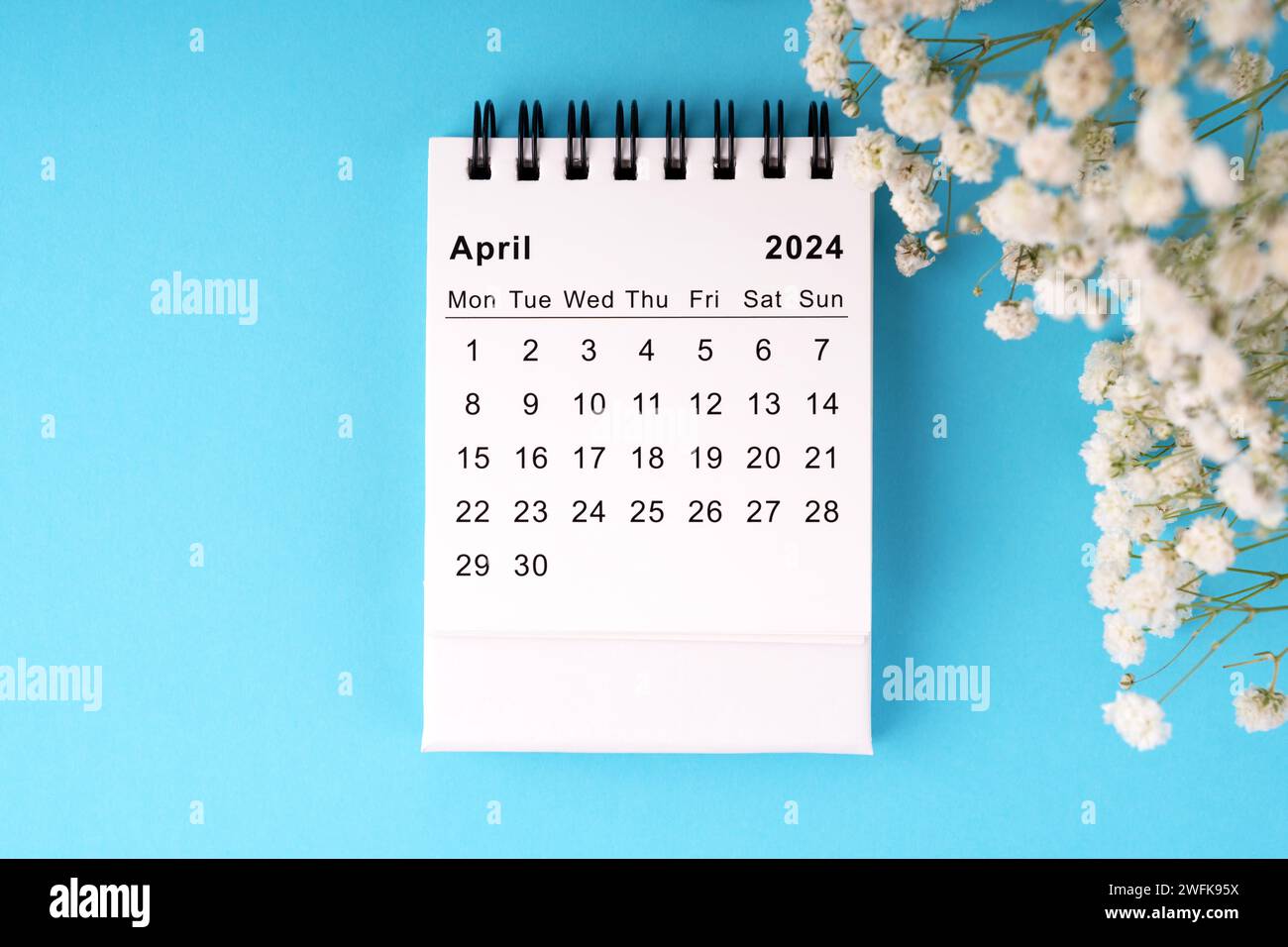 April 2024 calendar flat lay on blue background Stock Photo Alamy