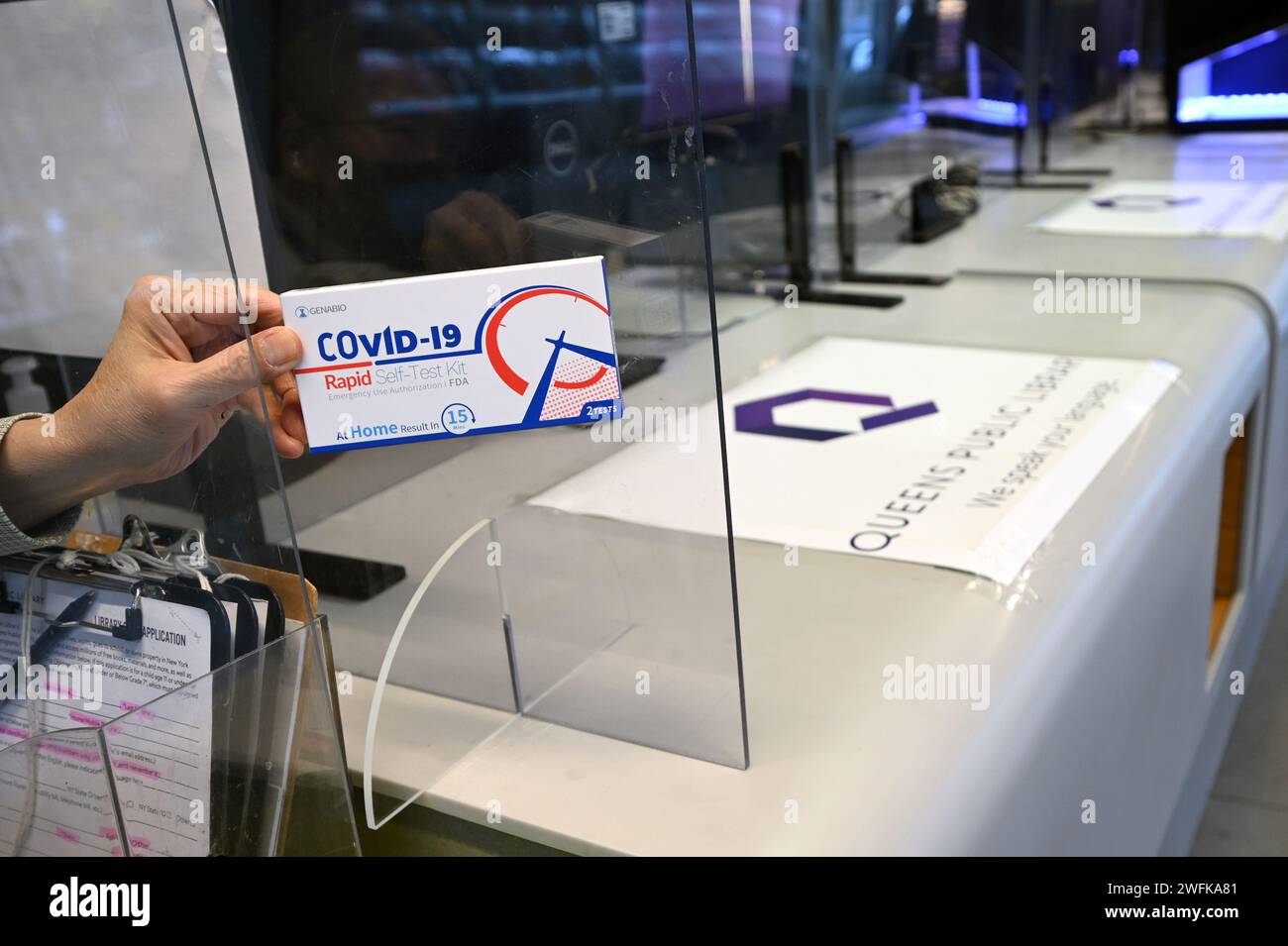 Test Kit Library A public library employee holds a COVID-19 rapid test kit available to ...