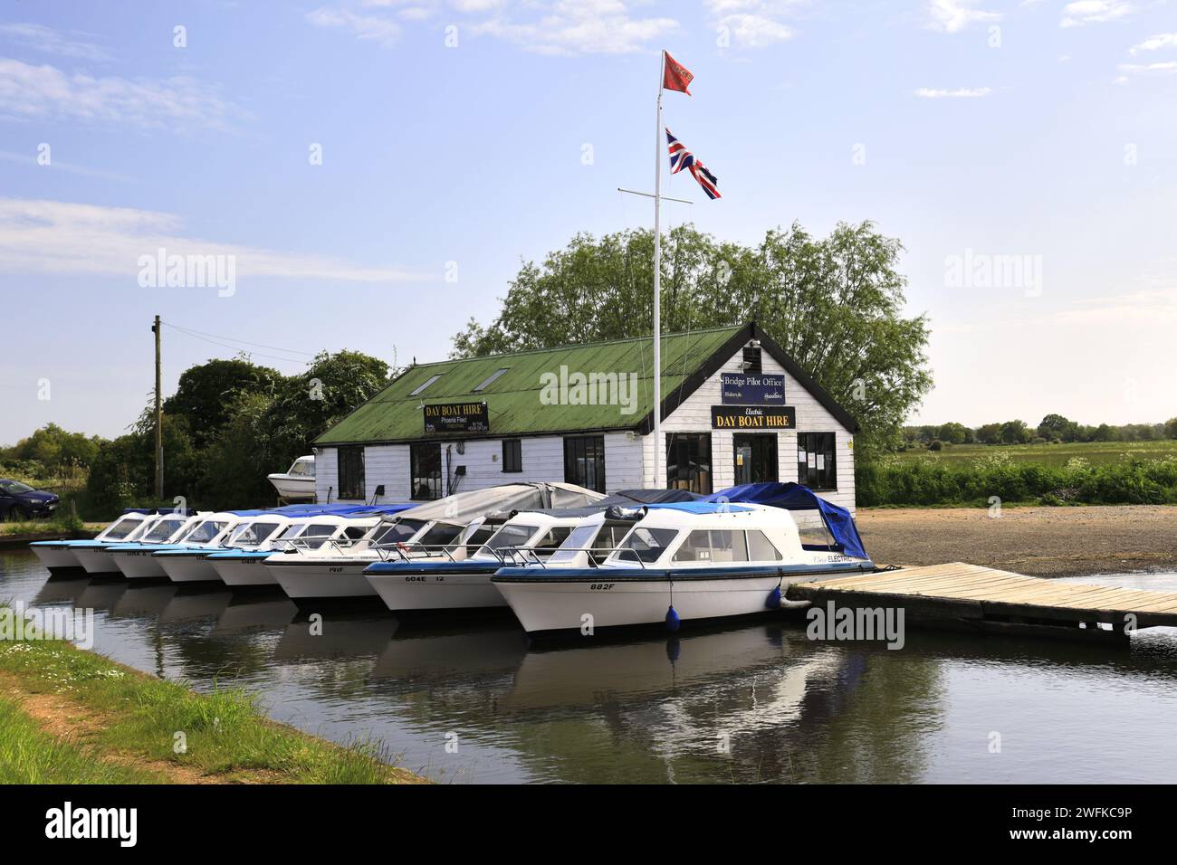 Summer view over boats at Potter Heigham village, river Thurne, Norfolk Broads National Park
