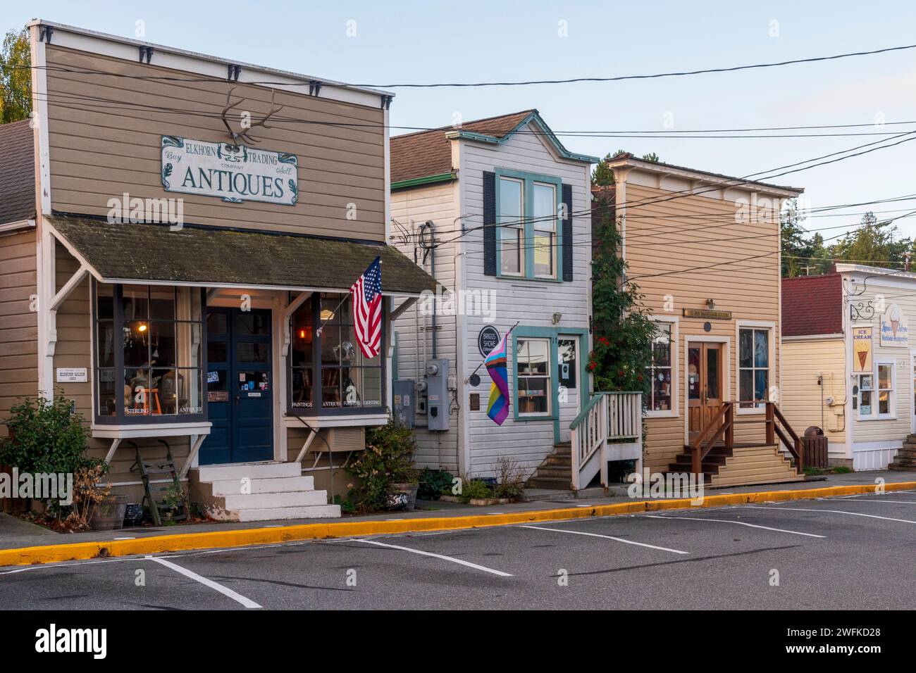 Horizontal photo of a row of historic wooden buildings housing retail and dining along Front Street in Coupeville, Whidbey Island, Wasington State. Stock Photo