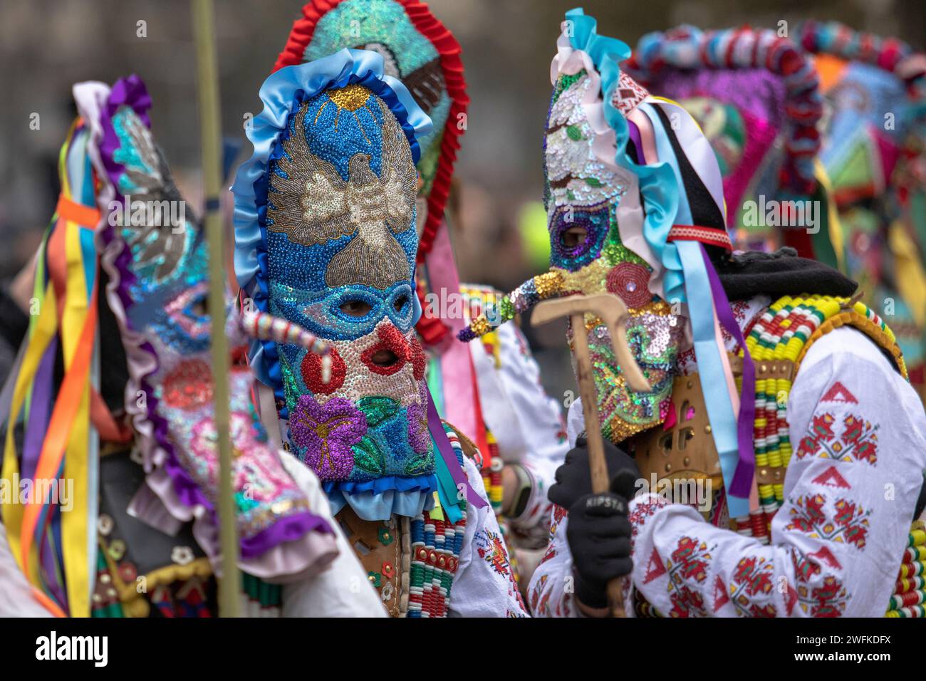 Pernik, Bulgaria - January 27, 2024: 30th anniversary Masquerade festival in Pernik Bulgaria. People with a mask called Kukeri dance and perform to sc Stock Photo