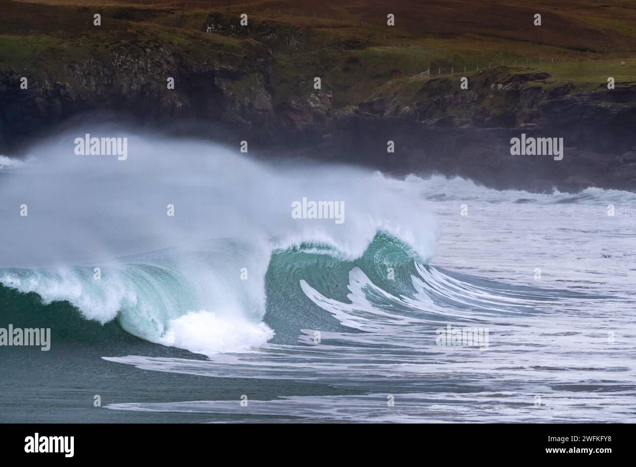 Large waves roll into the coast in the Port of Ness on the north east ...