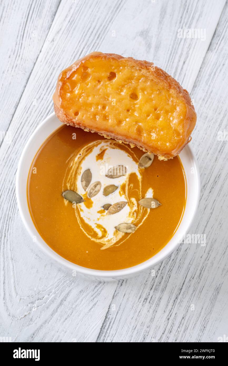 Bowl of spicy butternut squash creamy soup Stock Photo