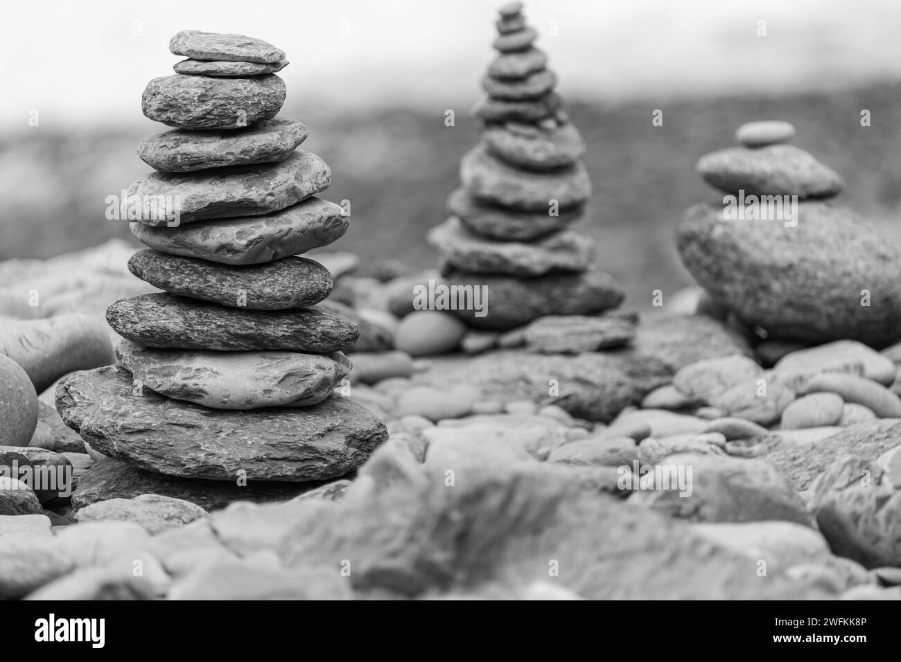 Close up of two towers of pebbles stacked up on a pebble beach Stock Photo