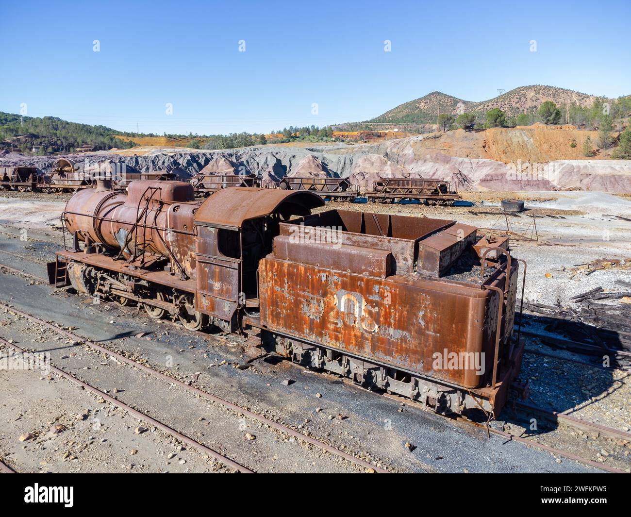 Aerial drone view of an old and rusty steam mining train used for transportation of the copper of  Corta Atalaya mining exploitation. Remains of the o Stock Photo