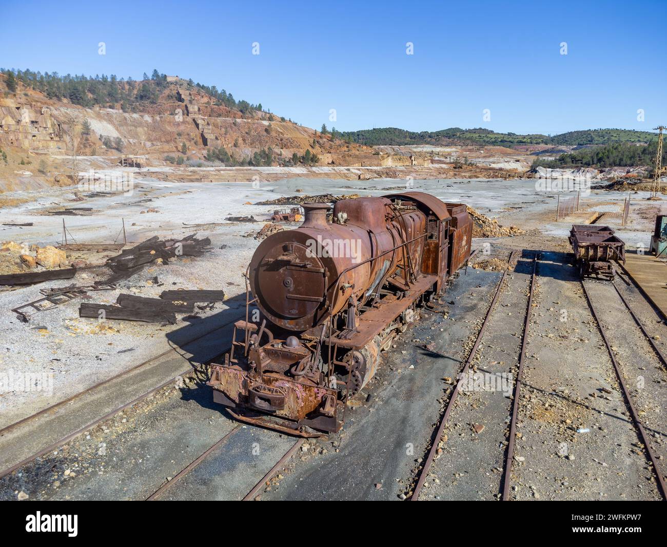 Aerial drone view of an old and rusty steam mining train used for transportation of the copper of  Corta Atalaya mining exploitation. Remains of the o Stock Photo