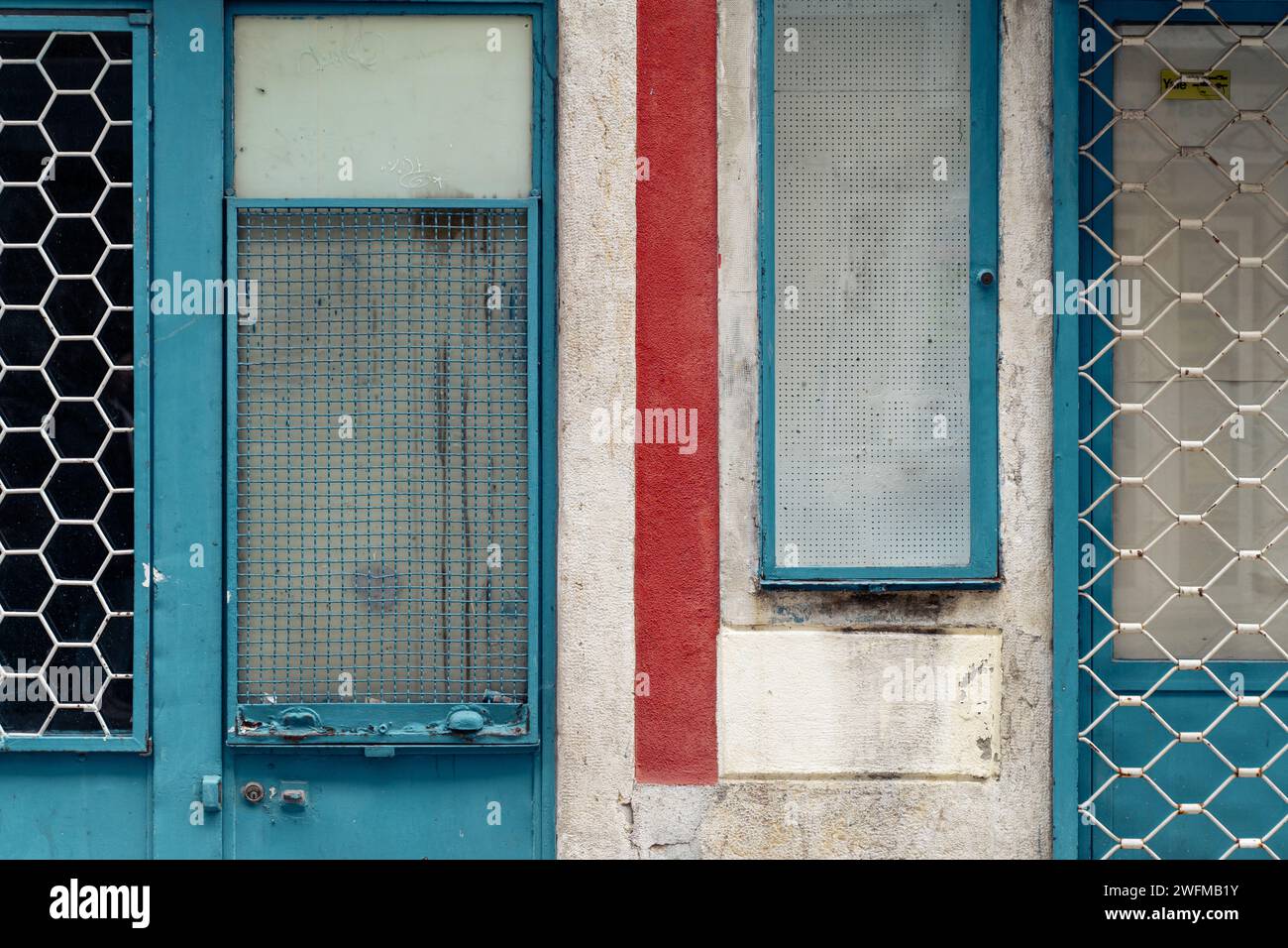 facade with old blue windows and shutters Stock Photo