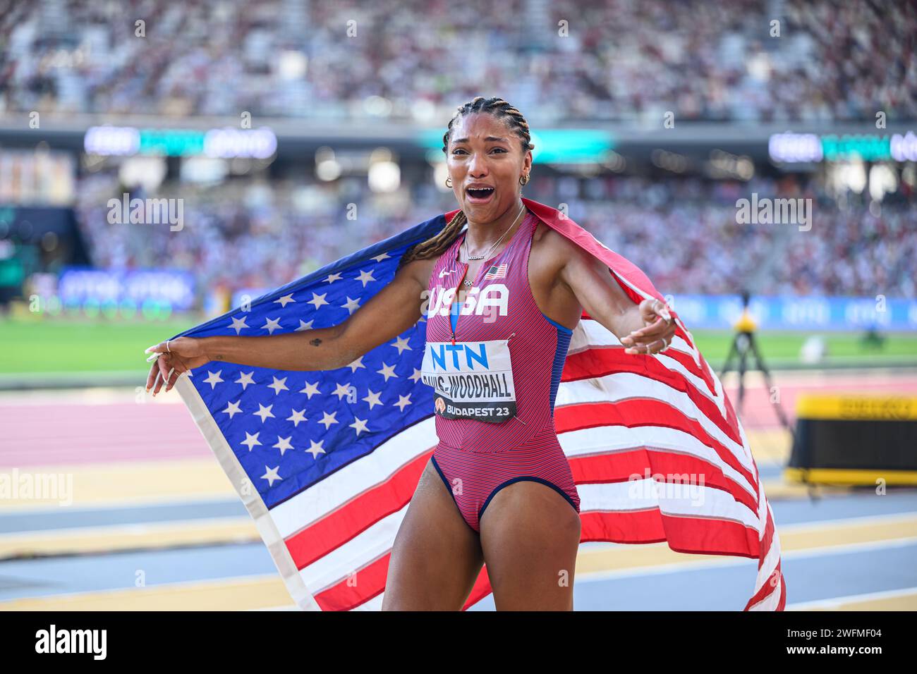 Tara Davis celebrating his medal with the flag in the Budapest 2023