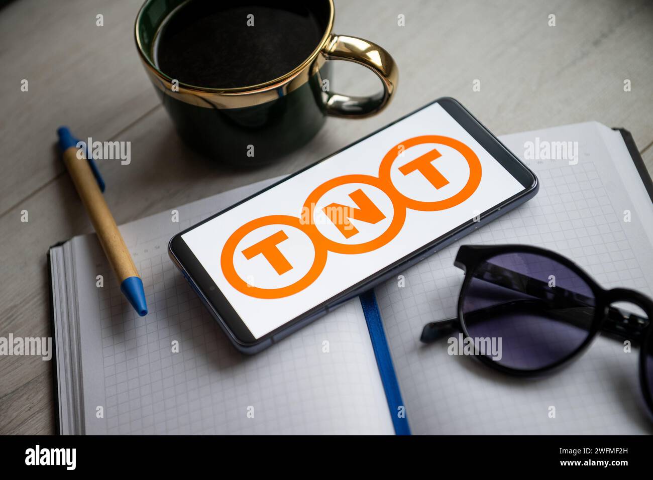 In this photo illustration a TNT logo seen displayed on a smartphone. Stock Photo