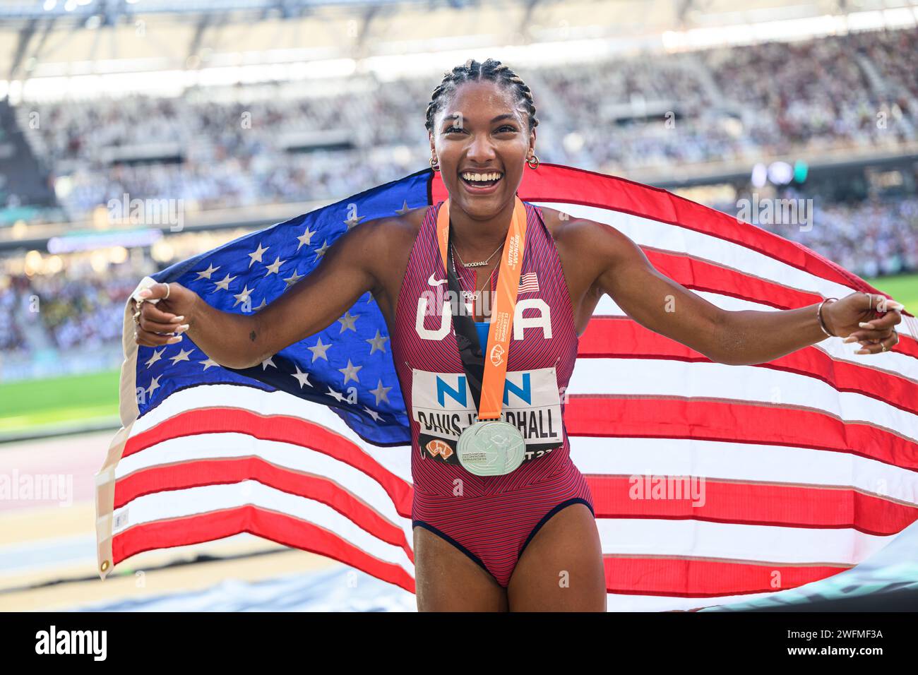Tara Davis celebrating his medal with the flag in the Budapest 2023
