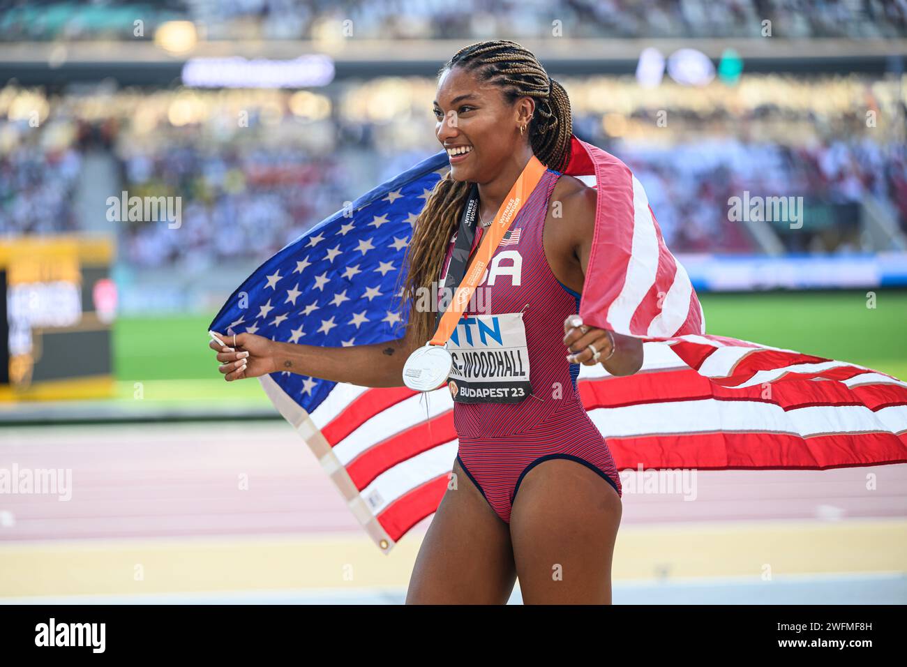 Tara Davis celebrating his medal with the flag in the Budapest 2023