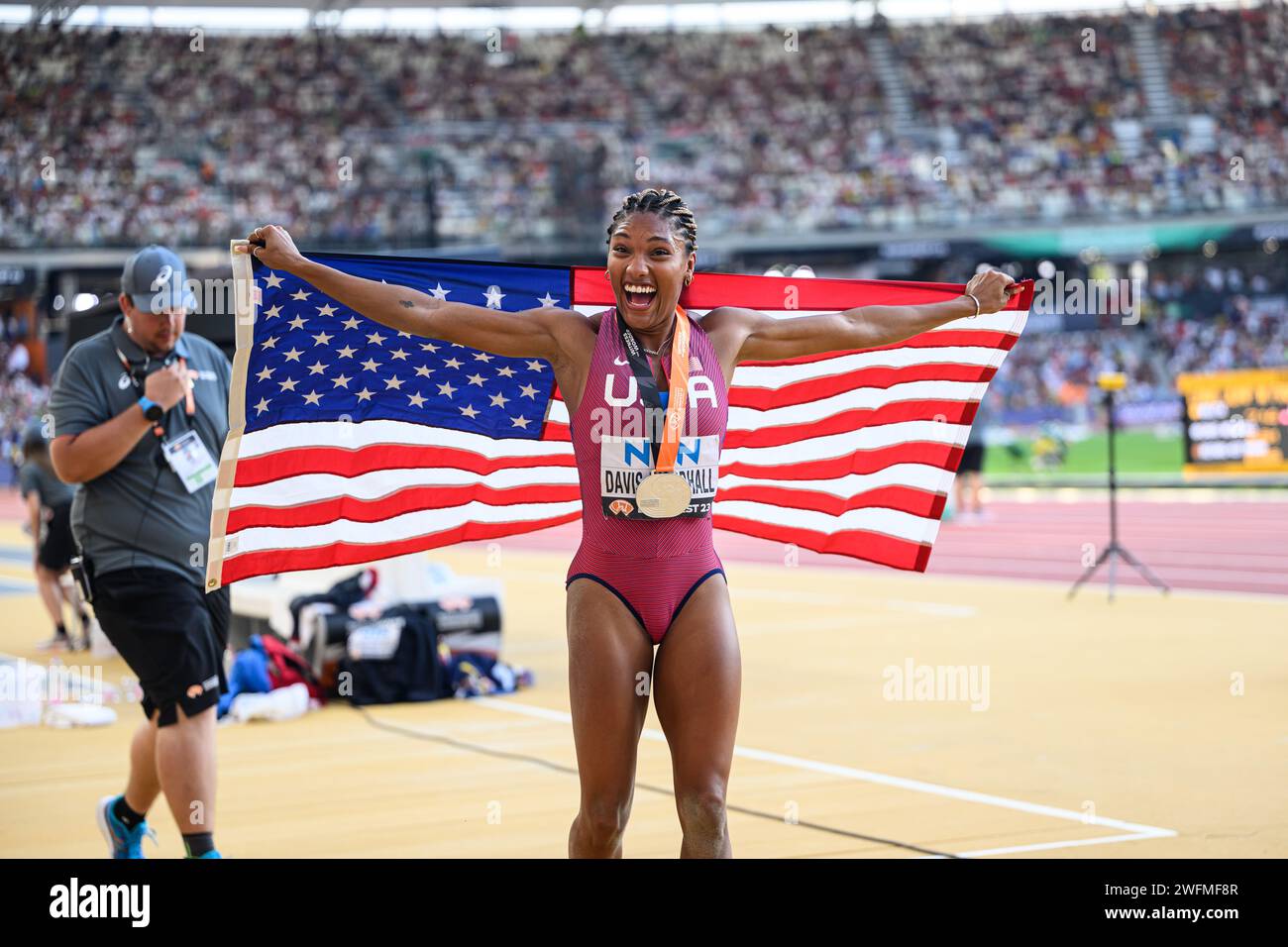 Tara Davis celebrating his medal with the flag in the Budapest 2023