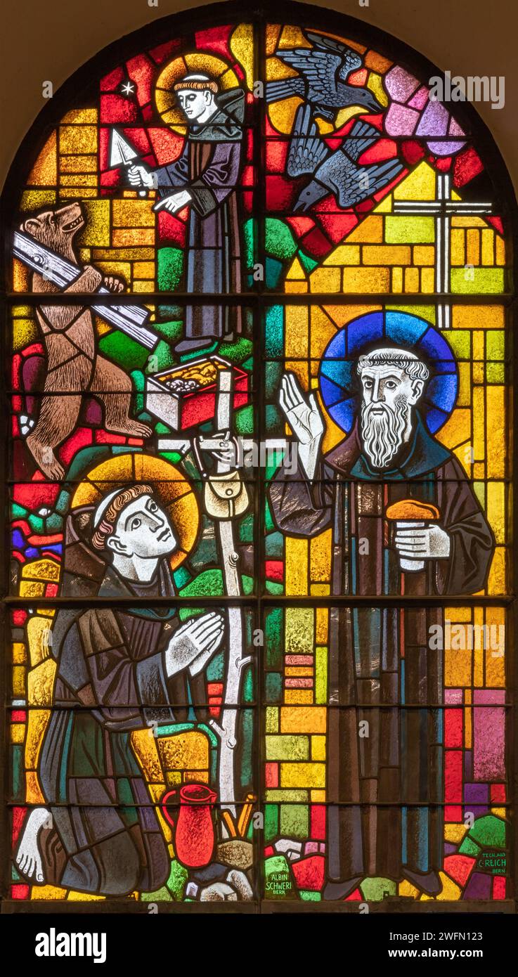 BERN, SWITZERLAND - JUNY 27, 2022: The and St. Gallus and St. Mainrad on the stained glass in the church Dreifaltigkeitskirche by A. Schweri (1938). Stock Photo