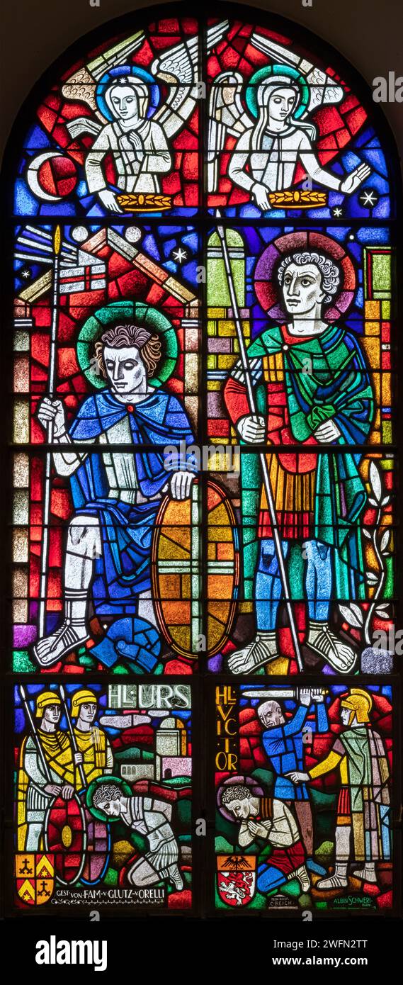 BERN, SWITZERLAND - JUNY 27, 2022: The St, Ursus of Solothurn and St. Victor on the stained glass in the church Dreifaltigkeitskirche by A. Schweri Stock Photo