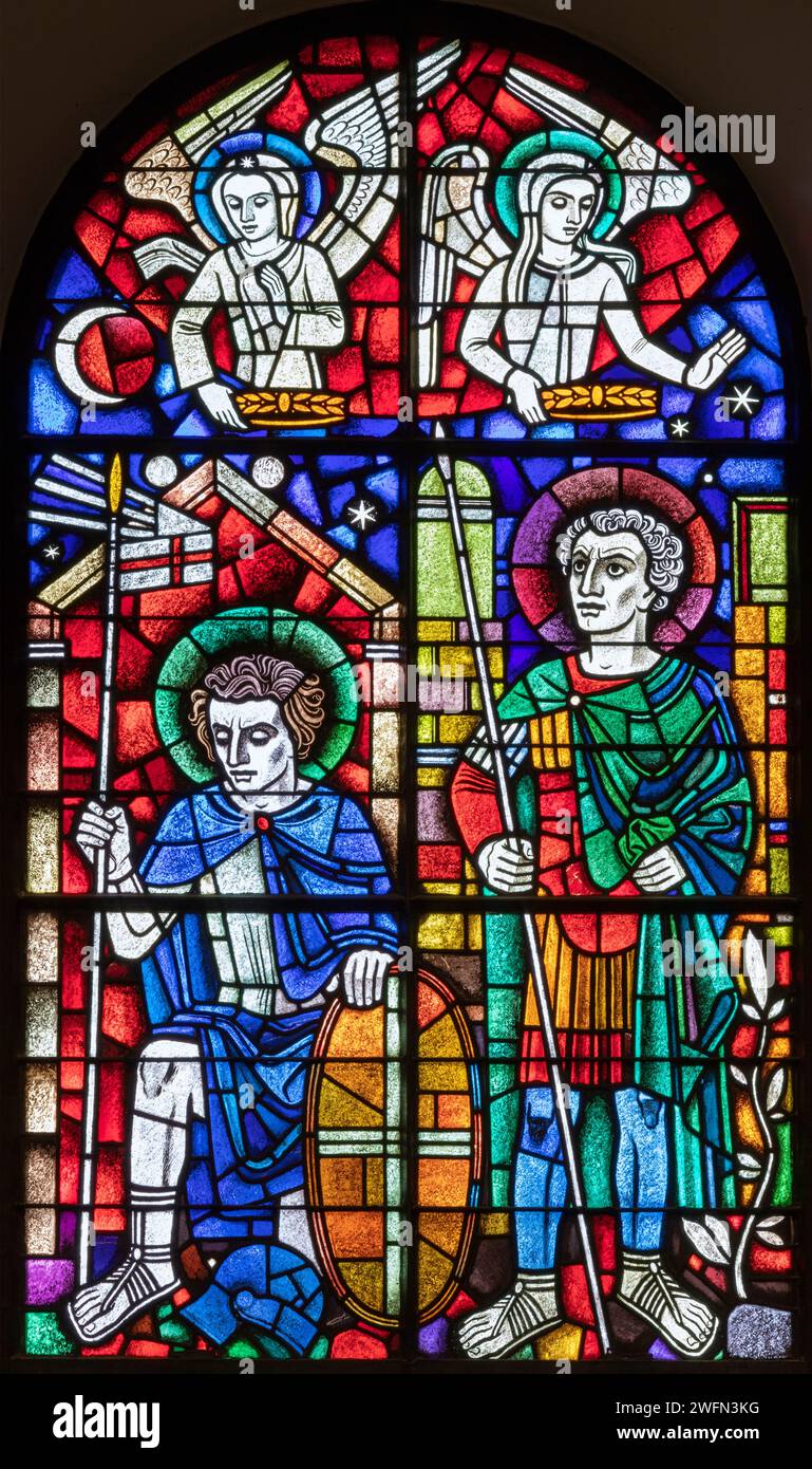 BERN, SWITZERLAND - JUNY 27, 2022: The St, Ursus of Solothurn and St. Victor on the stained glass in the church Dreifaltigkeitskirche by A. Schweri Stock Photo