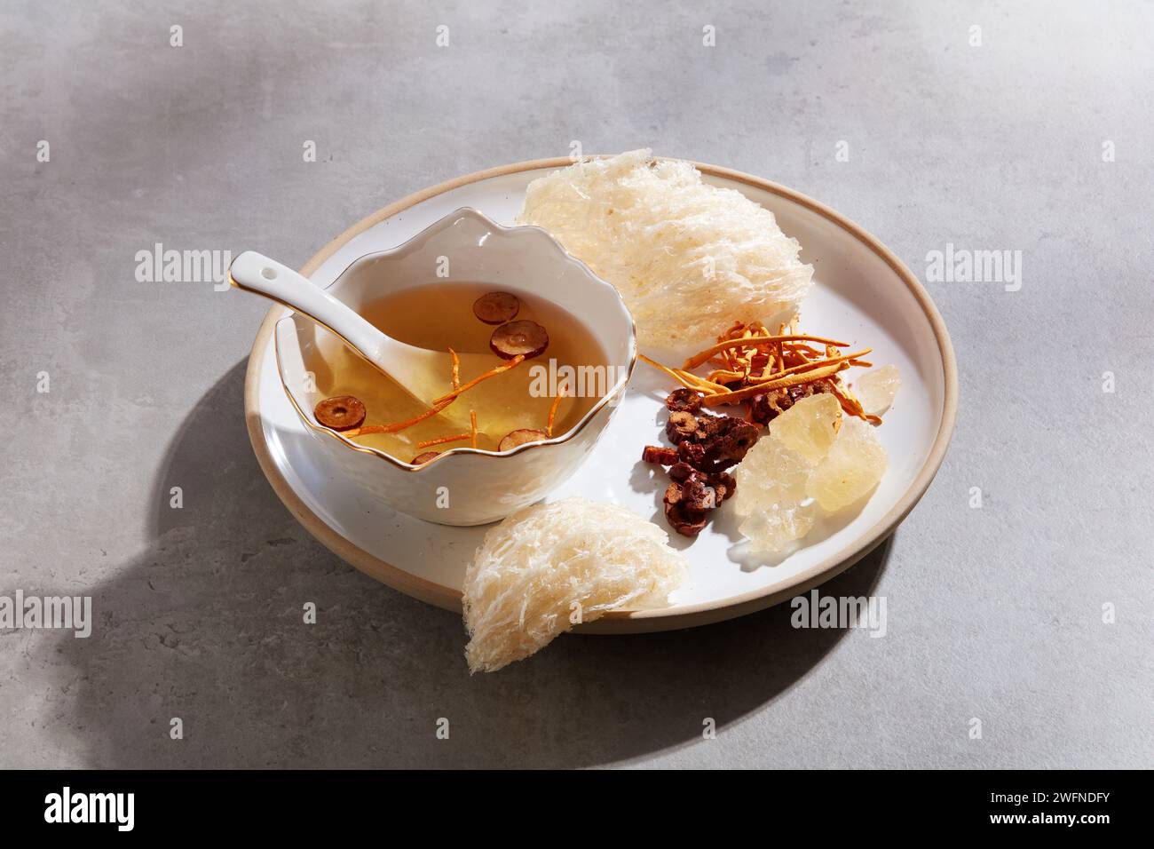 Edible bird nest displayed with a bowl of bird nest soup with jujube