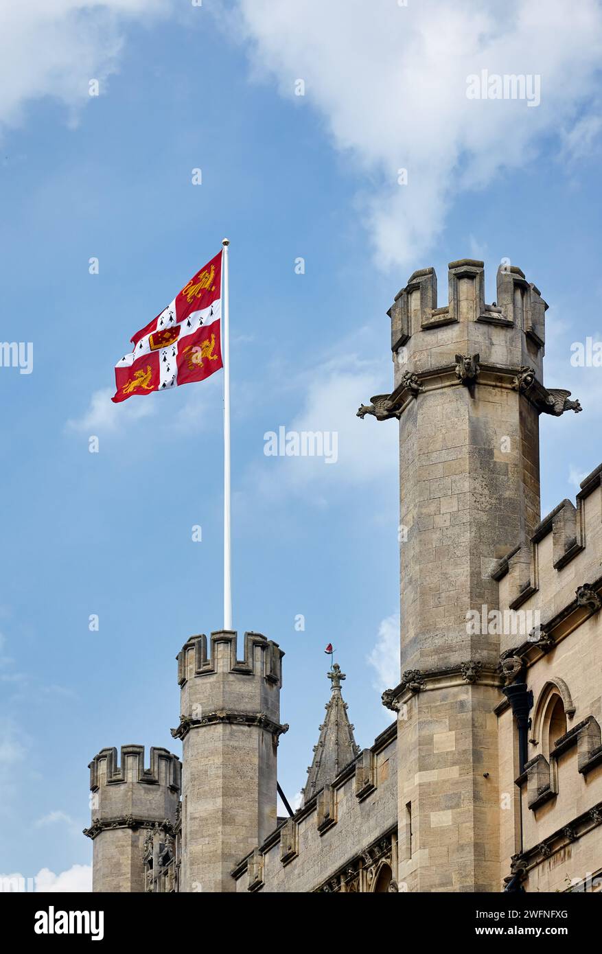 Flag of the University of Cambridge waving over battlemented walls and ...