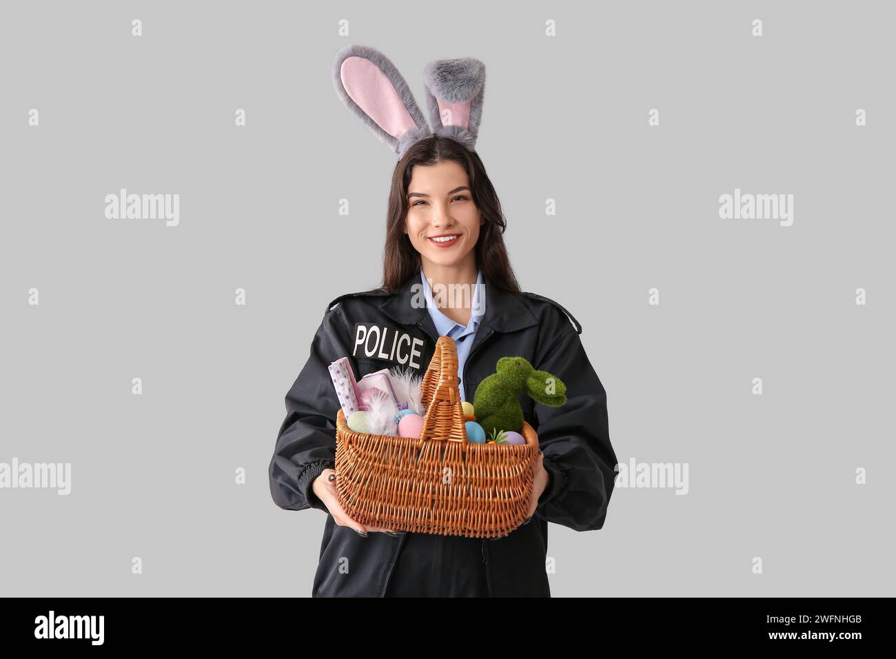 Police Rabbit Easter Female police officer in bunny ears with Easter eggs on light ...