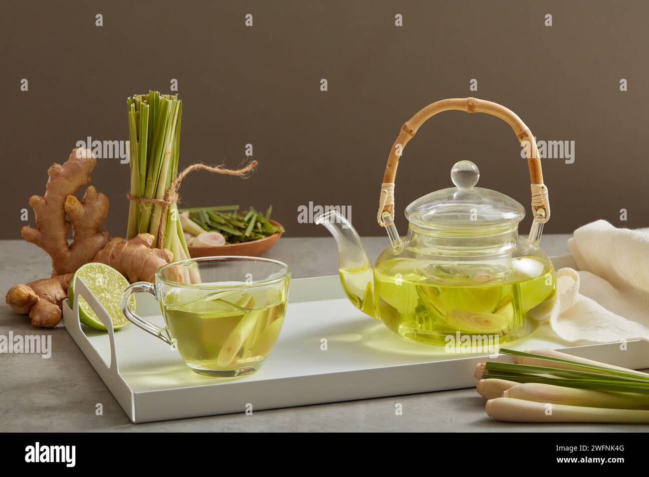 A glass transparent teapot and cup full filled with tea made with