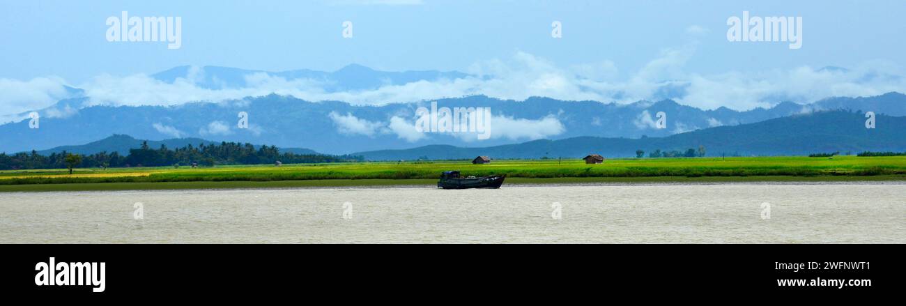 Misty mountains after a rainy morning seen from the Kaladan river in Rakhine State in Western Myanmar. Stock Photo