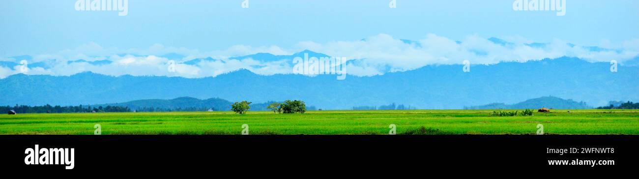 Misty mountains after a rainy morning seen from the Kaladan river in Rakhine State in Western Myanmar. Stock Photo