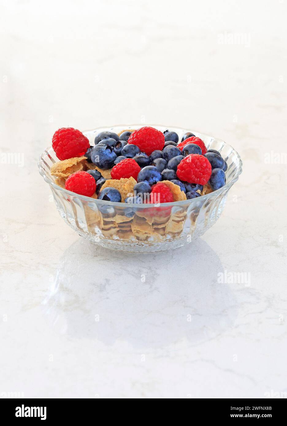 Bowl of oat flakes with blueberries and raspberries Stock Photo