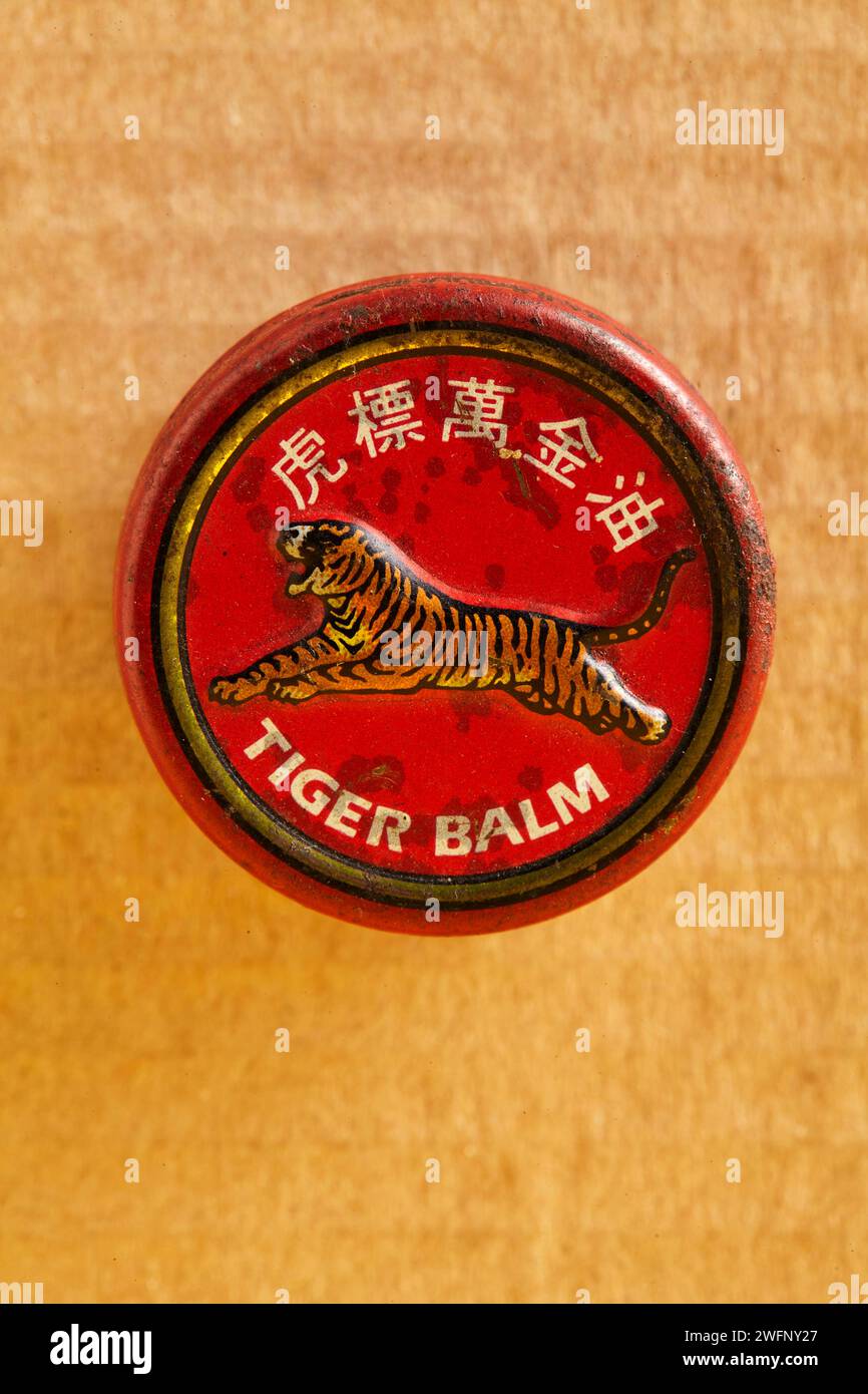 The front view of an old can of traditional Chinese balm containing a