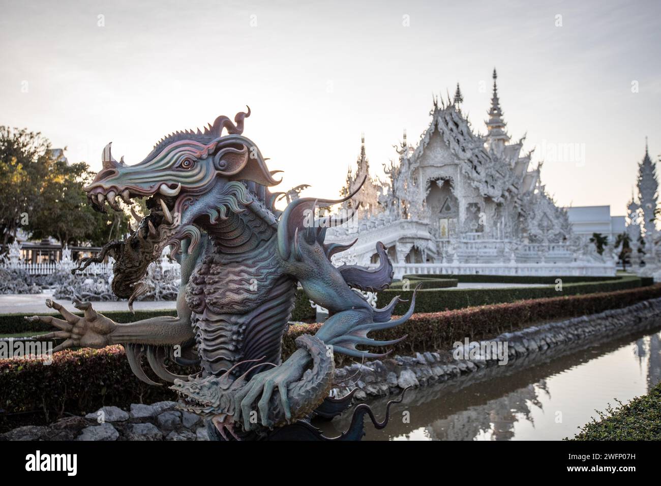 Chiang Rai, Thailand. 19th Jan, 2024. A sculpture outside the gate of the White Temple. The 'Wat Rong Khun' most commonly known as the 'White Temple' was designed and constructed by famous Thai artist Chalermchai Kositpipat and opened to visitors in 1997. The Temple attracts a large number of visitors daily, both locals and tourists which makes it the number 1 attraction in Chiang Rai, Northern Thailand. Credit: SOPA Images Limited/Alamy Live News Stock Photo