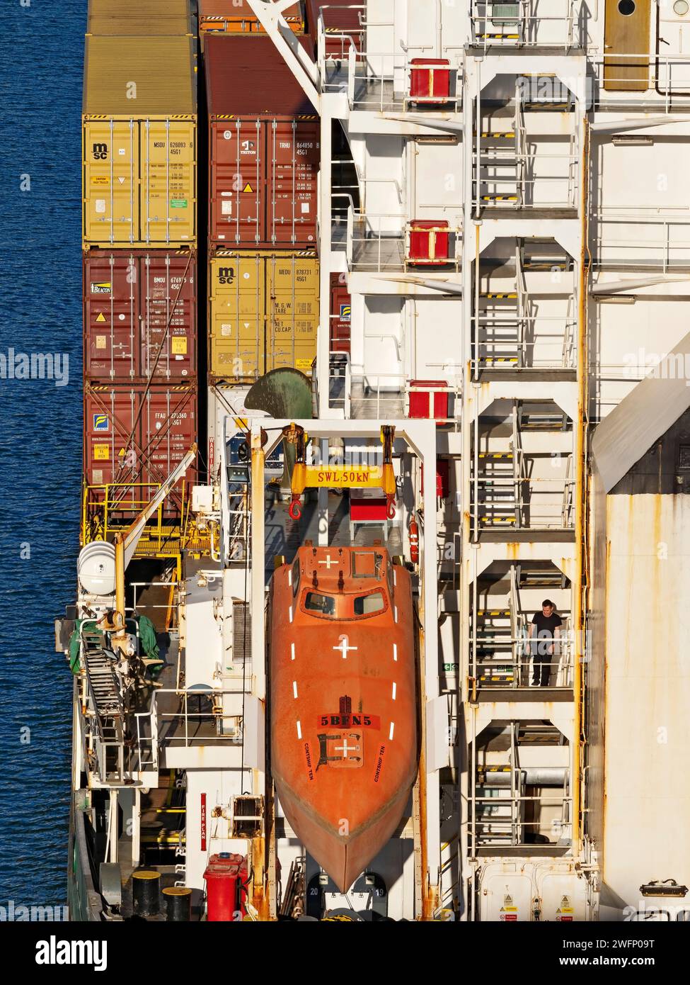 Shipping Industry /  Free fall lifeboat stowed on container ship's stern in the Port of Noumea, New Caledonia. Stock Photo