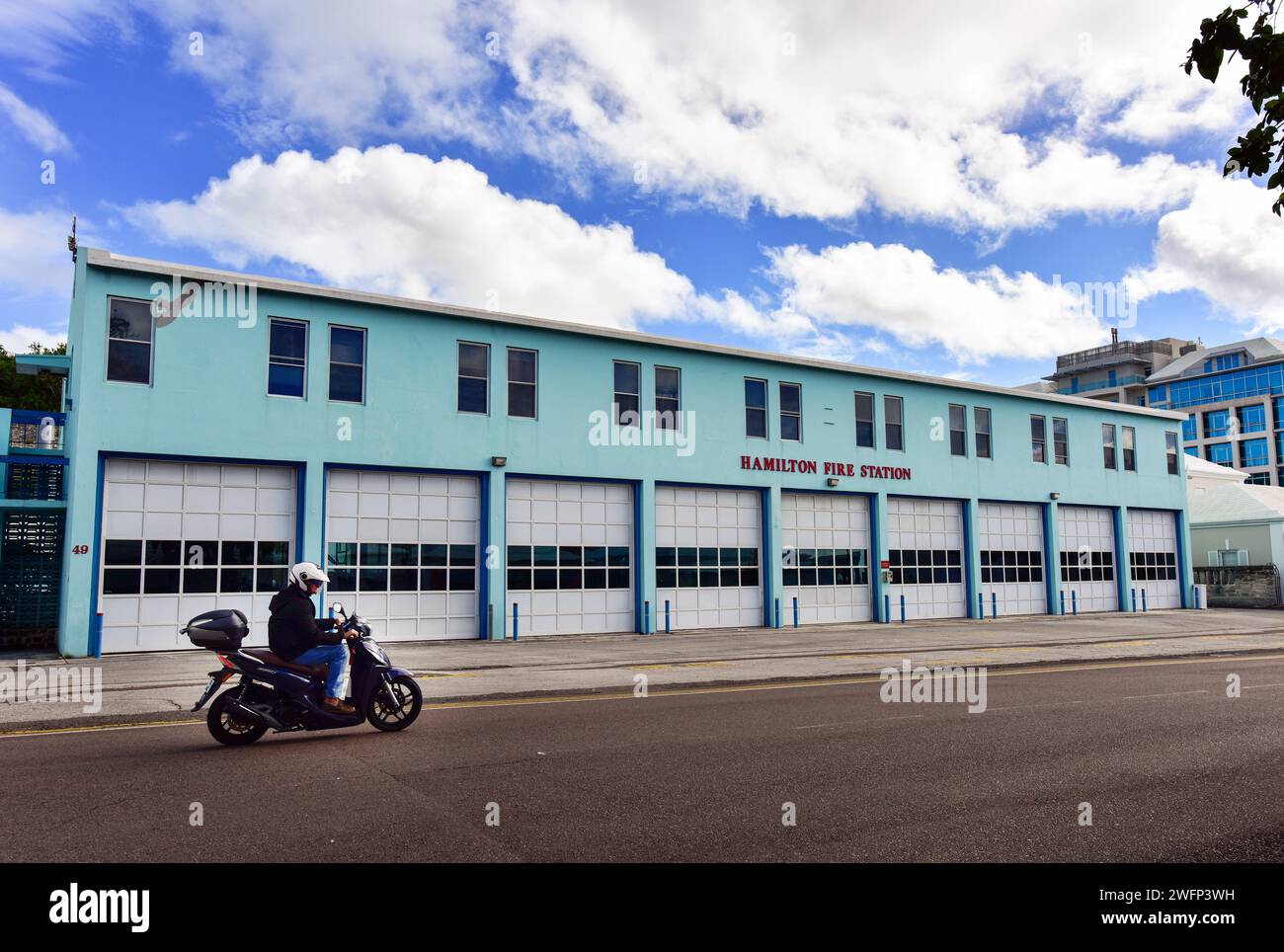Hamilton Bermuda Fire Station with a motorcycle driving by Stock Photo